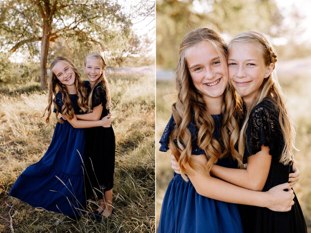 sisters hugging each other while smiling at camera