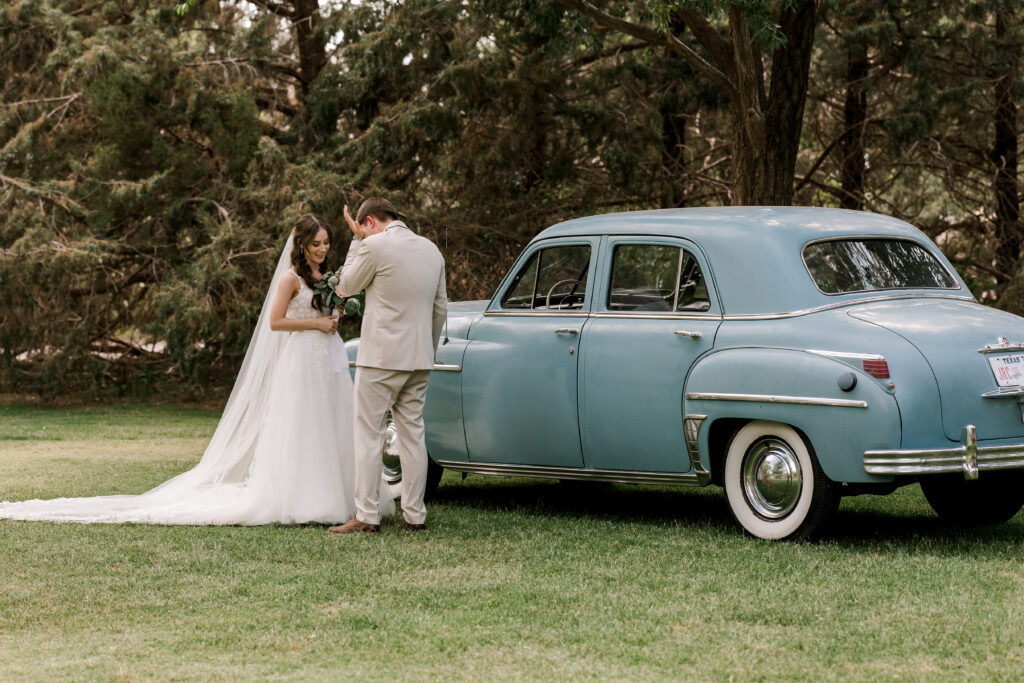 Lubbock wedding first look, mary wiebe photography captures groom tearing up during vow exchange.
