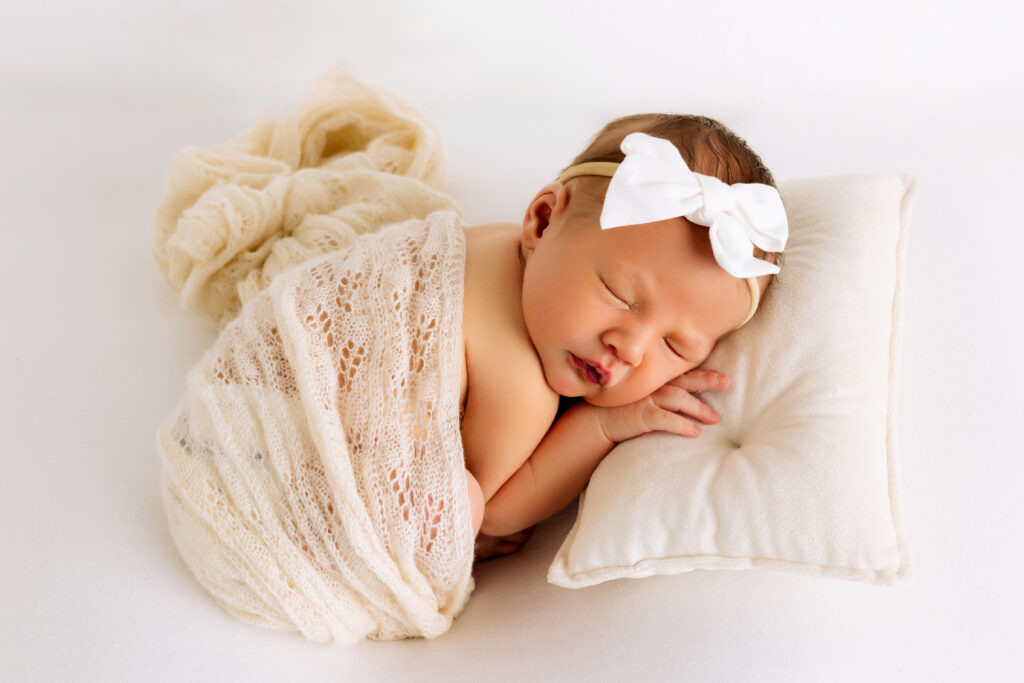 Lubbock newborn photography, Mary Wiebe, captured this newborn session where baby girl is sleeping while swaddled up. 