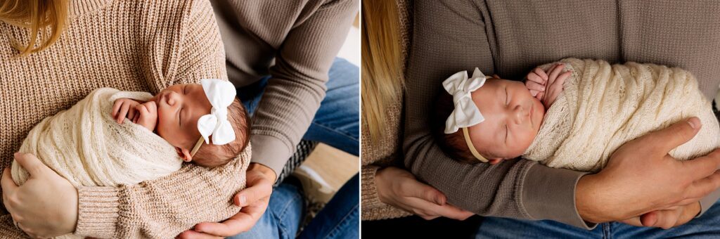 Dad and mom are holding their newborn daughter in their arms during this newborn session taken by Mary Wiebe Photography. 