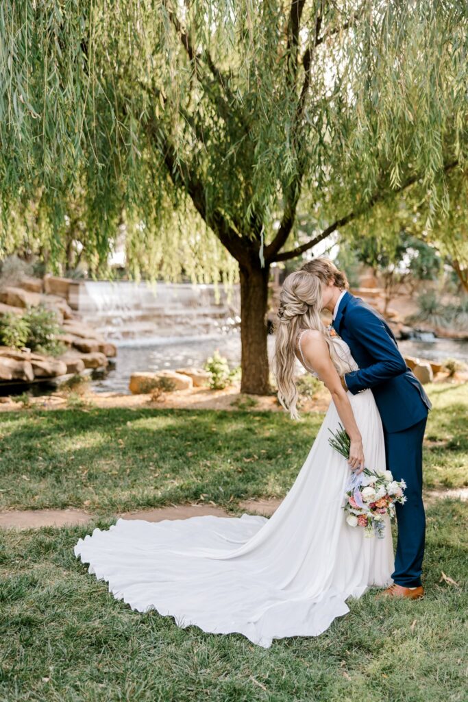 Bride and groom kissing for a portrait.