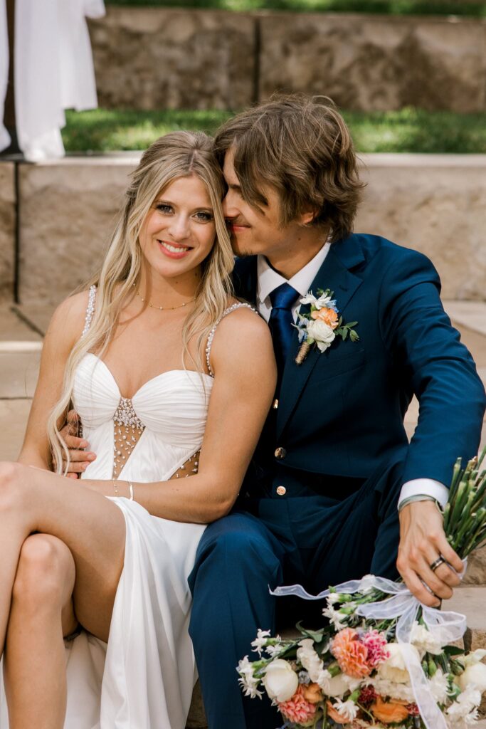 Bride and groom sitting on the steps of the venue sharing an intimate moment before guest arrive.