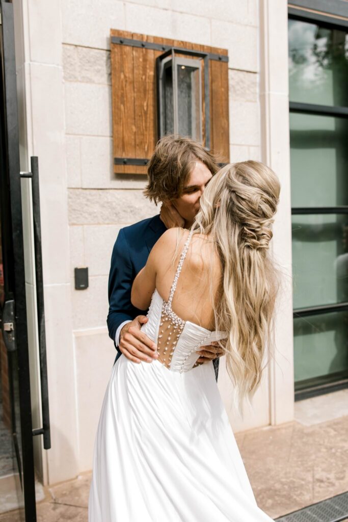 Bride and groom kissing at the end of the aisle after they are pronounced Mr. & Mrs.