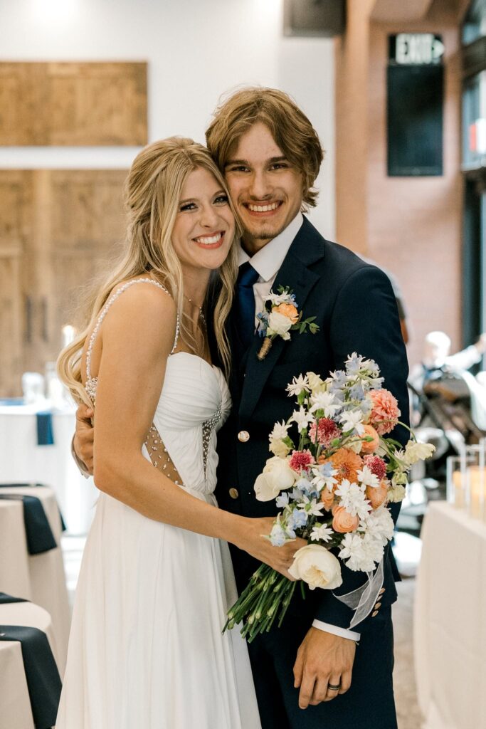 Briana and Colton's wedding day at the Willows Event Center. Bride and groom, smiling at the camera.