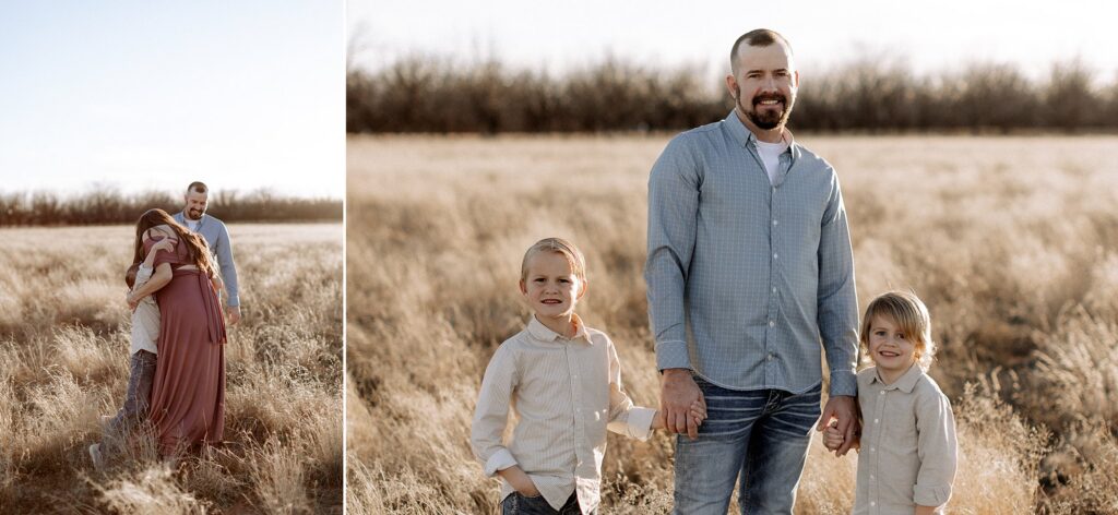 Dad is holding the hands of his two little boys, one on each side.