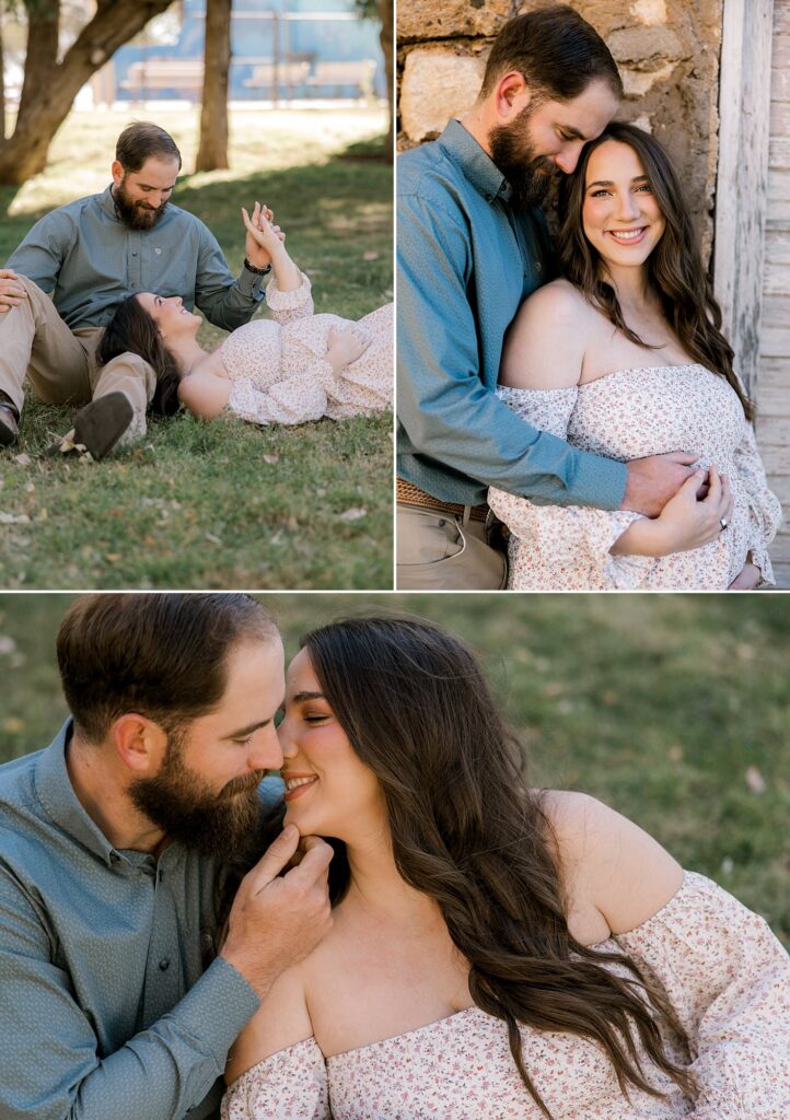 Couple is sitting on the ground while husband is placing his hand on his wife's chin. 