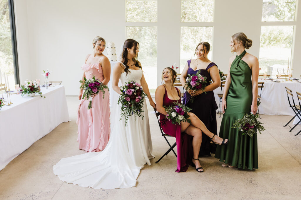 fun photo of the bride and bridesmaids laughing at each other.