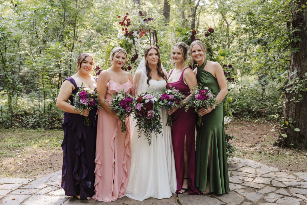 Bride and bridesmaids portraits in the ceremony location at Merrick Hollow Wedding in Merrick Oklahoma