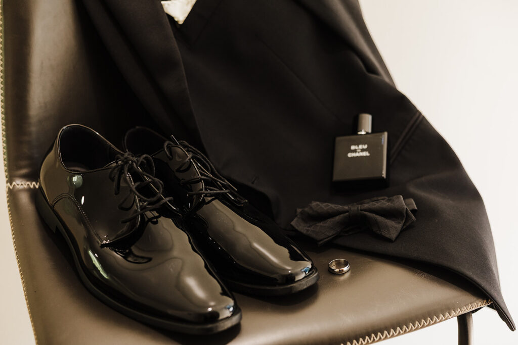 groom details of his cologne, shoes, bow tie and ring.
