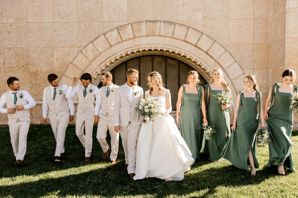 Seminole Texas wedding photo of bride and groom along with their bridal party walking and laughing.
