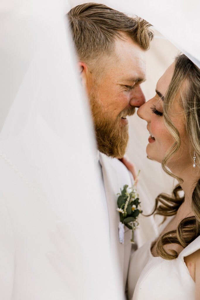 Bride and groom going in for a kiss during portrait time.