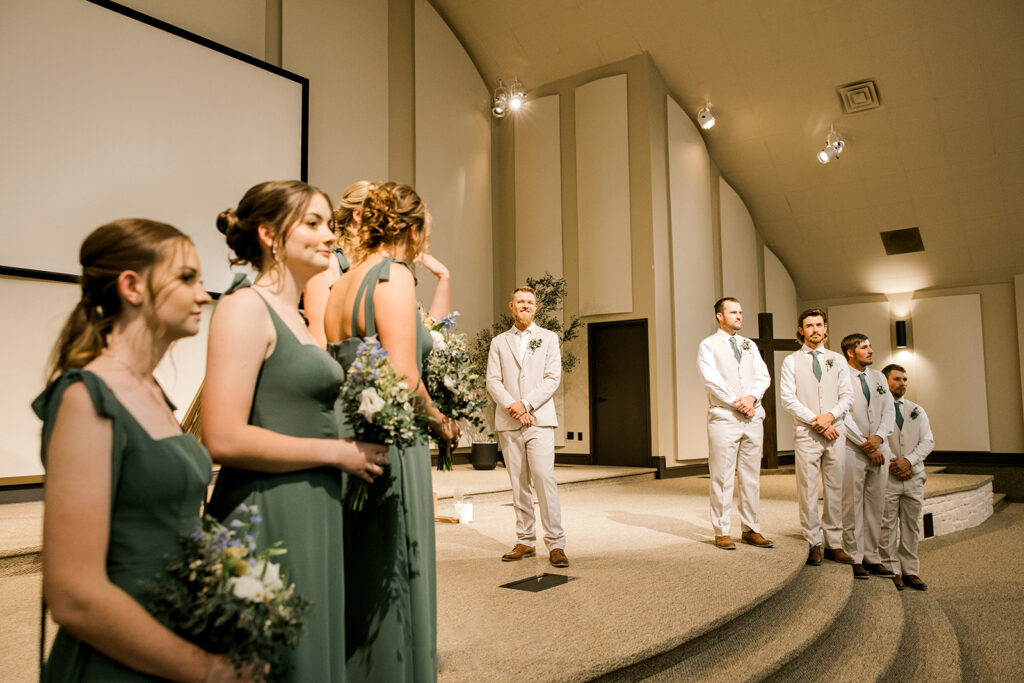 Groom watching the bride walk down the aisle during a Seminole, Texas wedding.