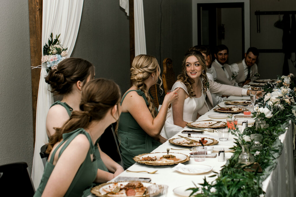 bride and bridesmaids talking during reception.

