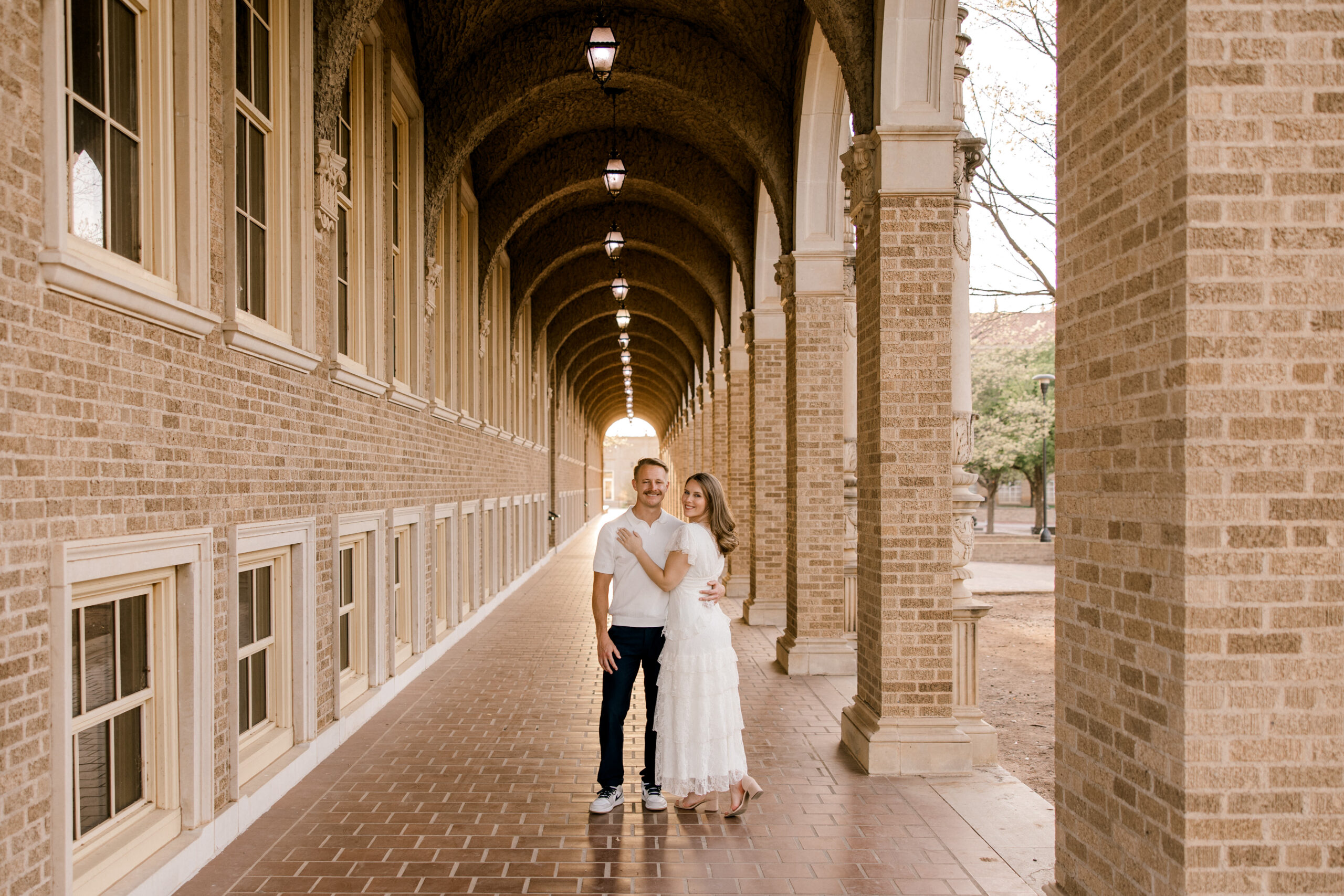Don't know what to wear for engagement photos? Here is an engagment photo where the woman is wearing a white dress, and the man a white shirt and dark jeans. Captured by Mary Wiebe Photography.