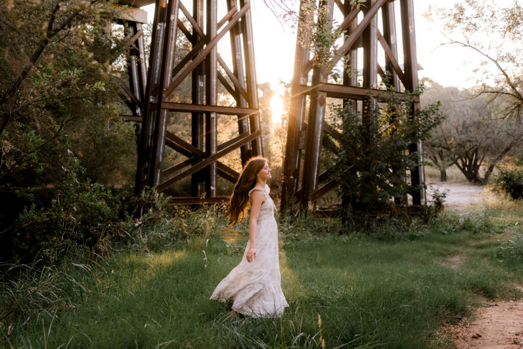 Choosing the best time of year for senior photos can be a challenge. This image show a summer senior session under a bridge. Captured by senior photographer, Mary Wiebe Photography. 