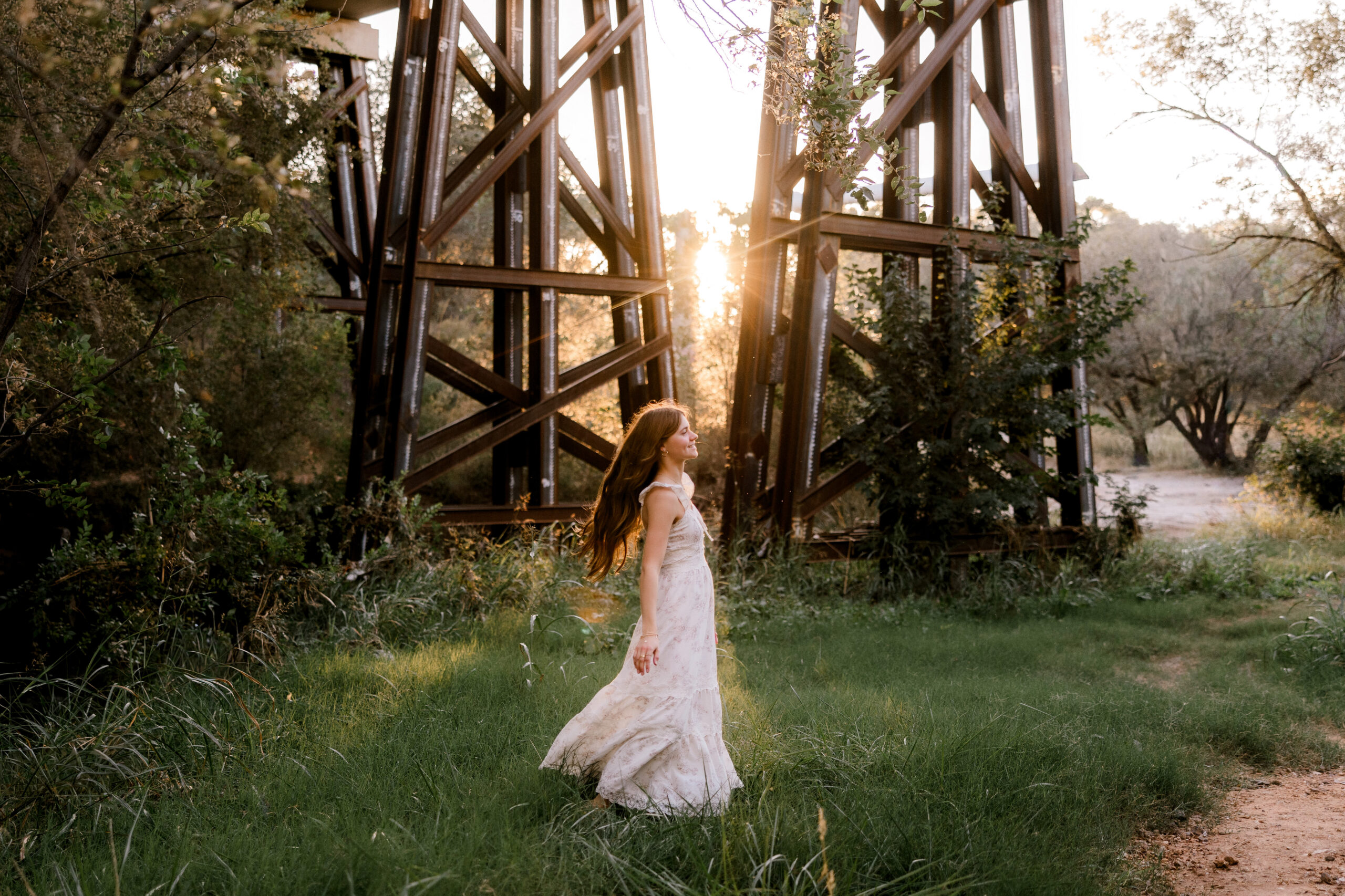 Choosing the best time of year for senior photos can be a challenge. This image show a summer senior session under a bridge. Captured by senior photographer, Mary Wiebe Photography.