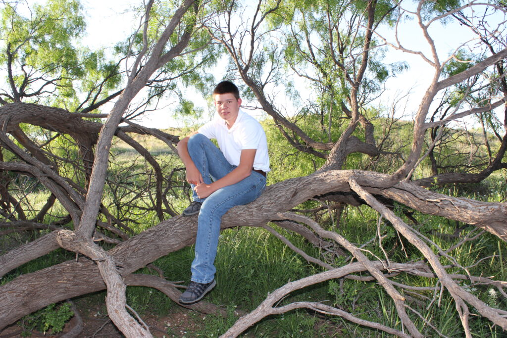 Photo of my son Steven Lee Wiebe, sitting on a tree branch.