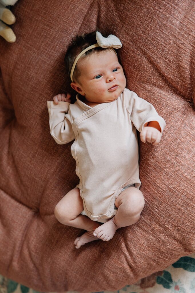 Newborn baby girl on a red mat. 