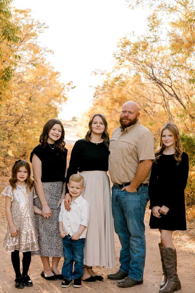 Family of six laughing while taking their fall family photos. 