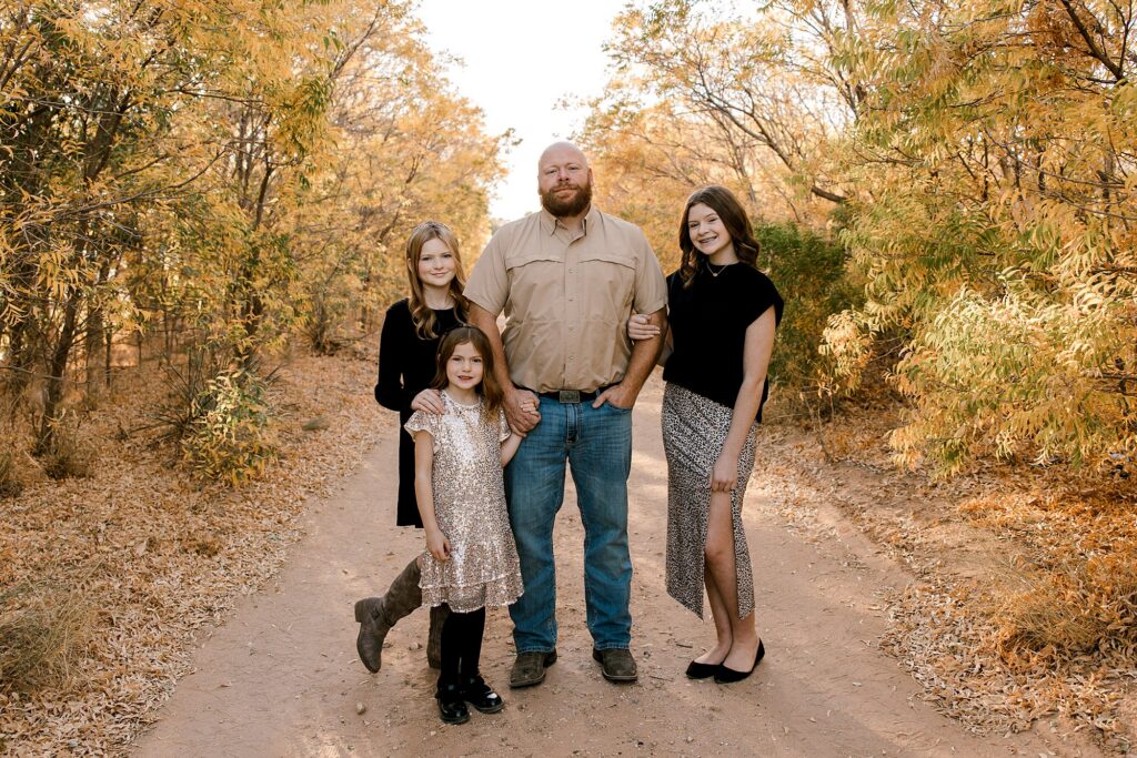 Dad with his three daughters enjoying the fall season. 