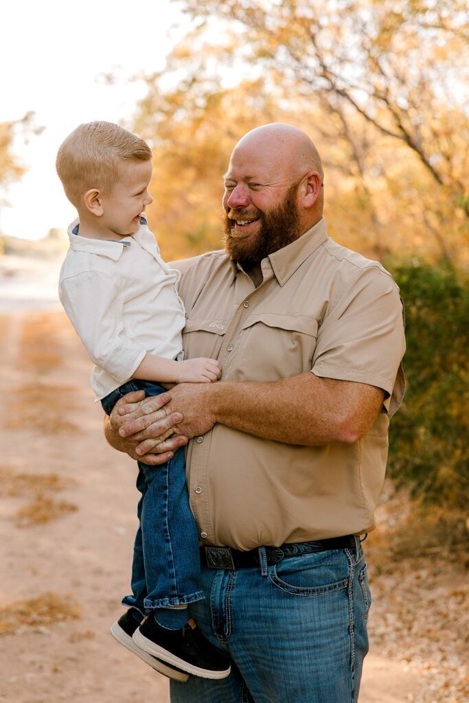 Dad and his son laughing at a joke that was told. 