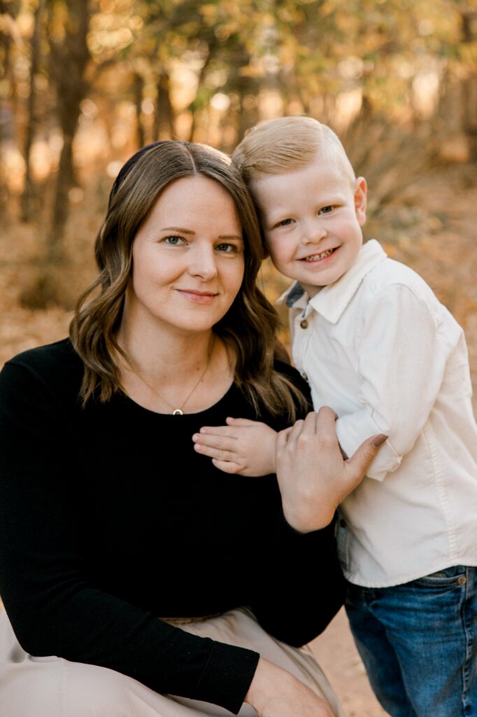 Mom and son holding each other. 