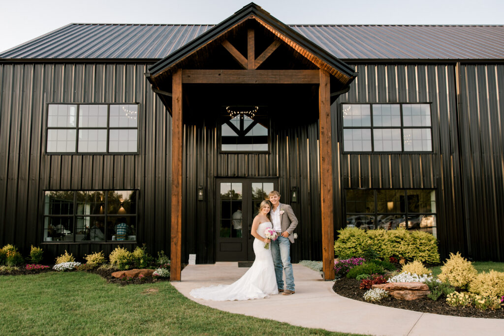 Timber Valley Ranch Wedding Photographer, Mary Wiebe, captured the bride and groom on their wedding day in front of the venue.