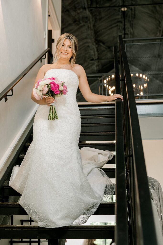 Bride is walking down the black steps at Timber Valley Ranch.