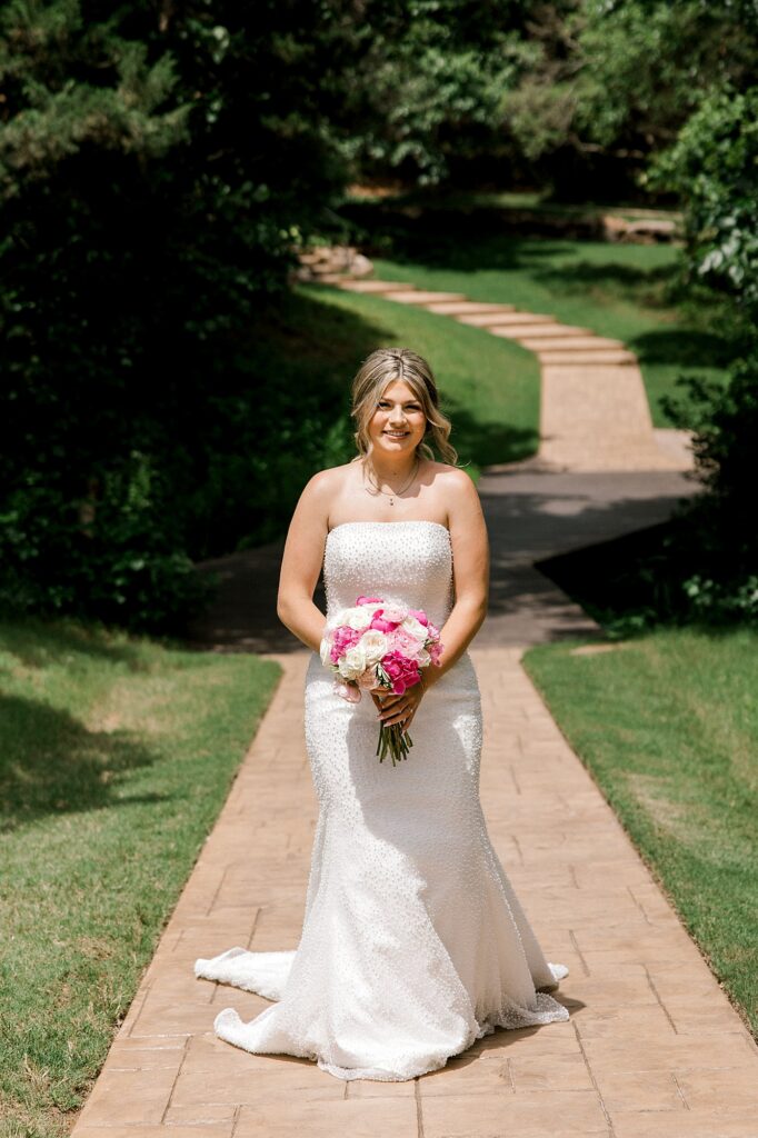 Bridal portraits taken by Timber Valley Ranch wedding photographer, Mary Wiebe. Bride is walking down a stone aisle.