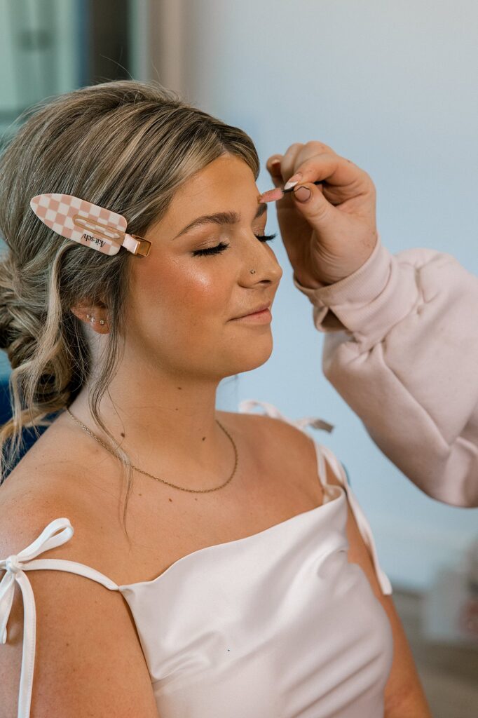 Bride getting her makeup done.