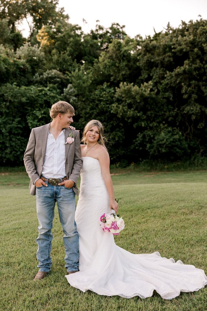 Bride and groom smiling for the camera.