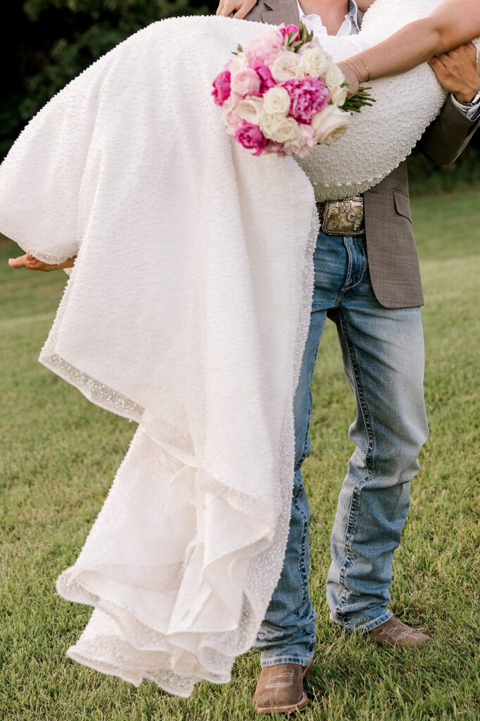 Photo focused on the buttons on the back of the brides dress. Captured by Mary Wiebe Photography.