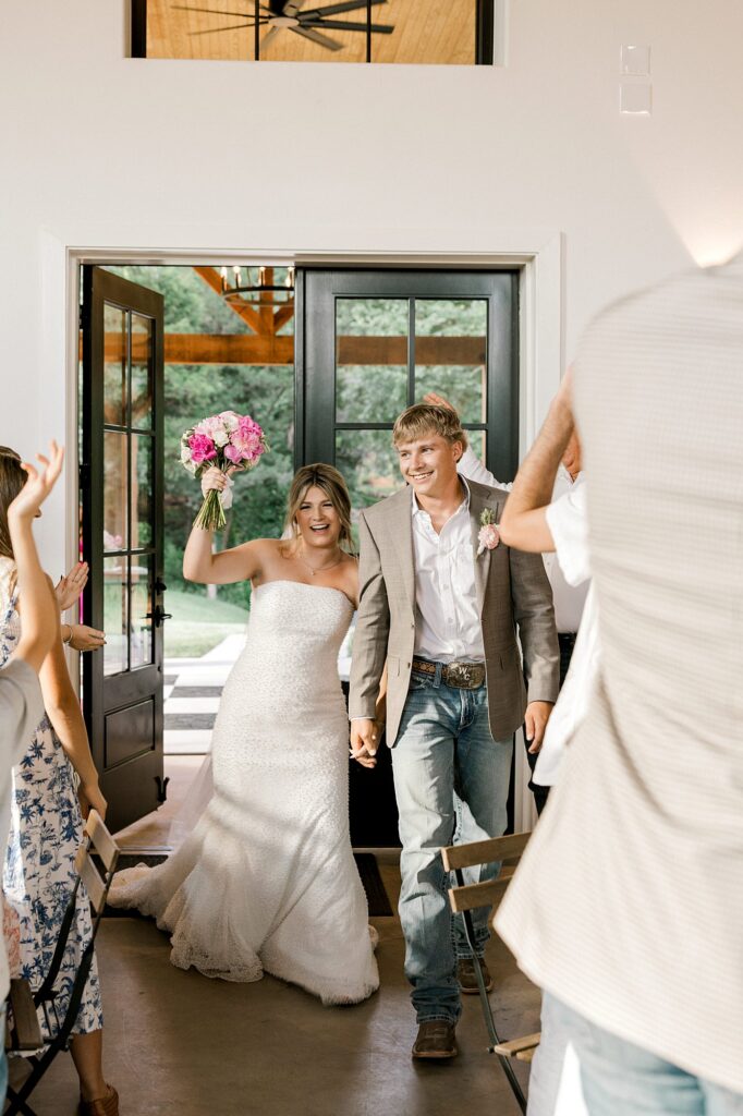Bride and groom enter the reception. Captured by Mary Wiebe Photography.