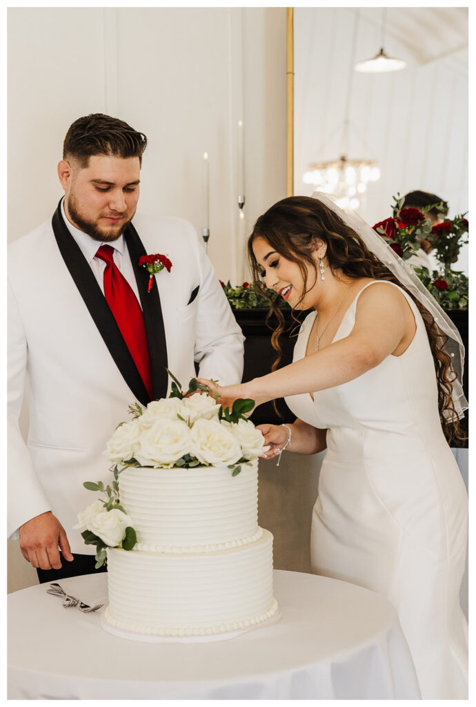 Bride and groom cut the cake inside Diamond Hill Wedding Venue in Seminole, TX with Mary Wiebe Photography capturing why hire a professional photographer