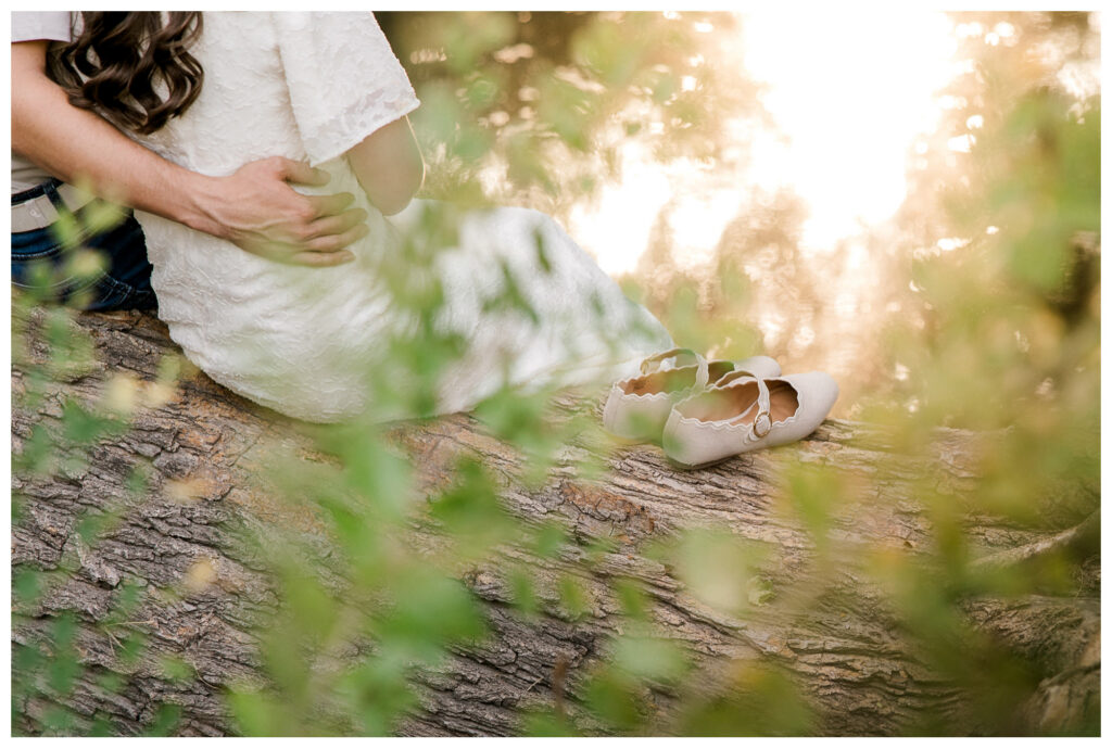Shoes sit on a log next to an engaged couple captured at Mackenzie Park in Lubbock, Texas with Mary Wiebe Photography
